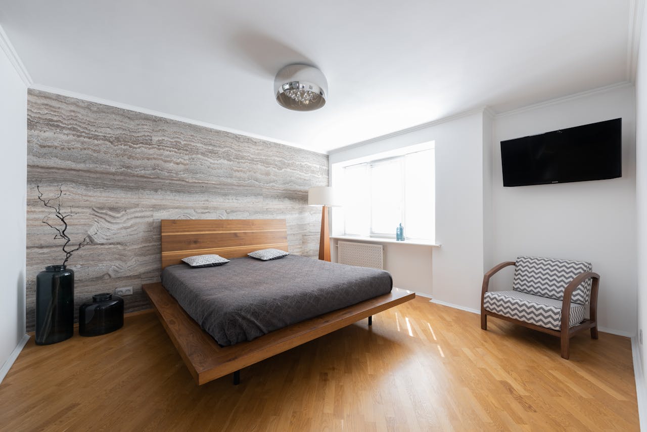 an hotel room with window, grey bedsheet, chandelier, wood flooring, free stock photo